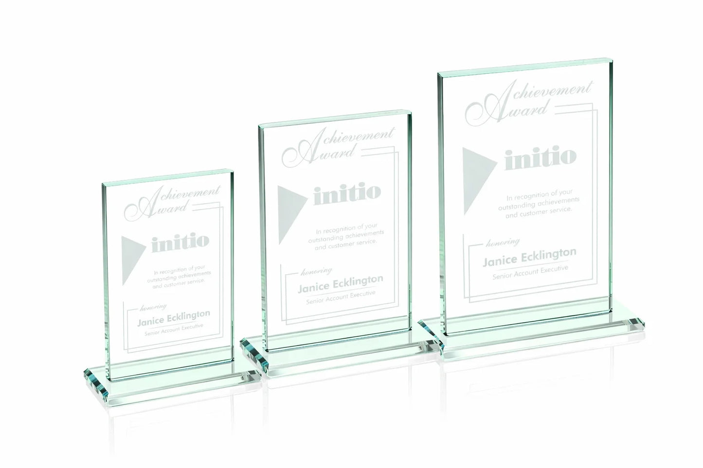 Three glass awards with 'initio' branding on a white background