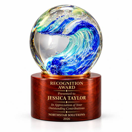 Marine Glow art glass sphere with blue ocean wave swirl on a wooden base
